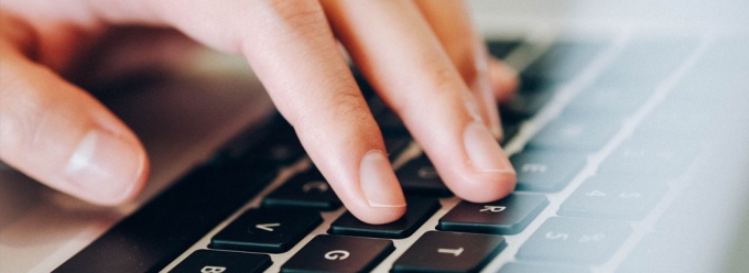 Hand typing on a computer keyboard